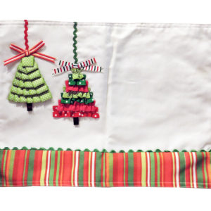 Christmas Placemat with embroidered trees on white fabric, perfect for holiday table decor. Size: 45cm x 32cm.