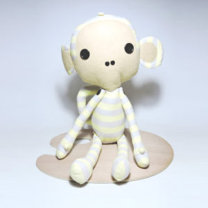image of a Striped Monkey Plush Toy with playful yellow and grey stripe patterns. Size: 57cm x 13cm.