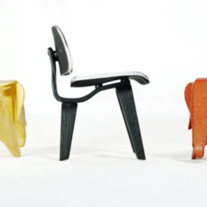 Miniature Eames Plywood Elephant: A charming brown and orange miniature replica of the iconic Eames Plywood Elephant. Miniature Eames DCW: A sleek black and white miniature replica of the renowned Eames DCW (Dining Chair Wood).
